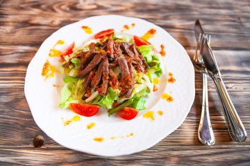 Spice Mexican salad with meat and vegetables on white plate