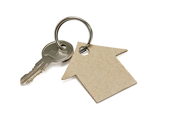 House made of cardboard and key on white background