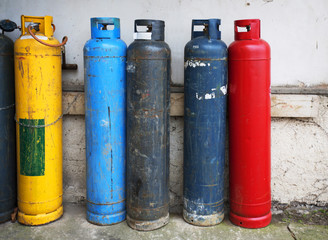 Gas cylinder. Industrial propane butane bombs. Row dirty gas cylinders. Yellow chemical bomb. Corroded welder container. Old heating bombs with valve. Pressurized container. Dangerous equipment.