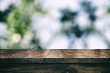 Fototapeta premium Empty top wooden table and floral blurred background