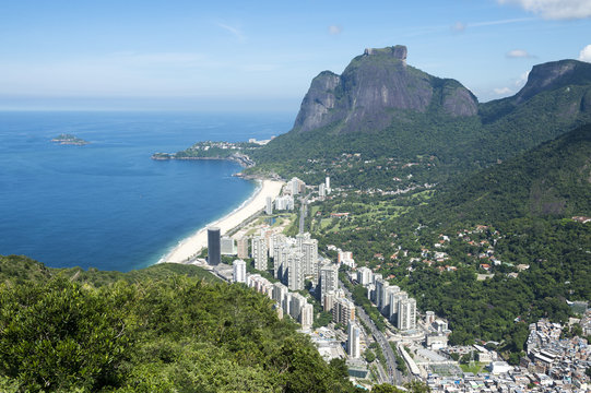 Scenic skyline view from above Sao Conrado Beach with Pedra da Gavea mountain and the favela community of Rocinha