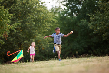 Girl and boy flying a kite