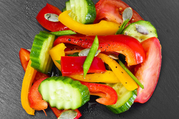Healthy and diet food: Lettuce, tomato, pepper, seeds, oil, salt