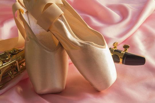 Saxophone and Ballet shoes on Pink silk fabric soft