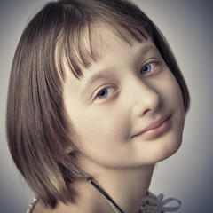 Portrait of the girl - teenager. He looks into the camera.
