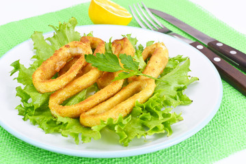 Fried Squid Rings in Breadcrumbs with Lettuce and Lemon