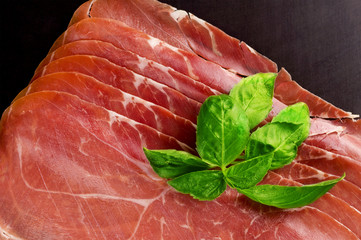 Prosciutto. Smoked pork rashers with basil
