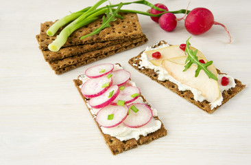 Bruschetta with cream cheese and fresh vegetables, fruits.