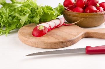 red radishes on wooden cutting board