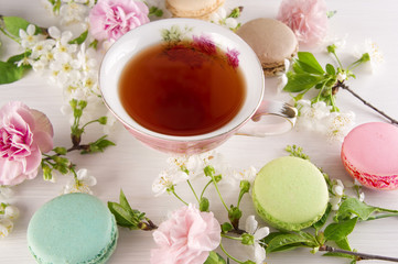 Tea with cherry blossom flowers, macaroons. Spring concept