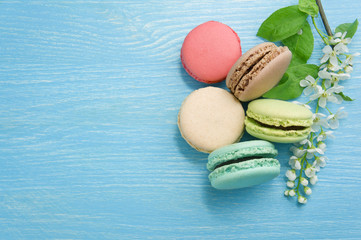 Different types of macaroons. Turquoise, chocolate and green col