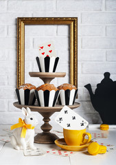 Still life Mad tea party with bunny and muffins