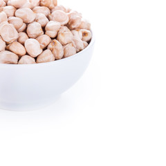 Raw dry chickpeas in bowl on white background