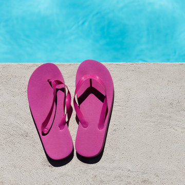 Pink slippers near swimming pool