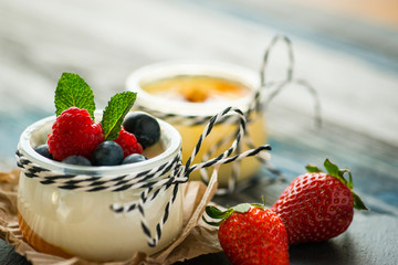 Jar with fresh yogurt on a rustic table
