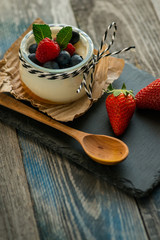 Jar with fresh yogurt on a rustic table