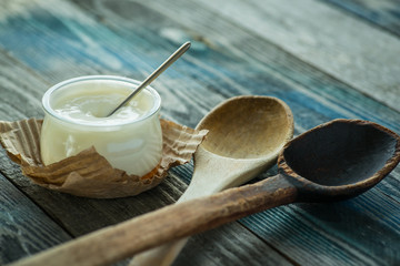 Jar with fresh yogurt on a rustic table