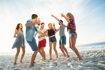 Friends dancing on the beach
