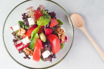 vegetable salad with feta cheese in a glass dish