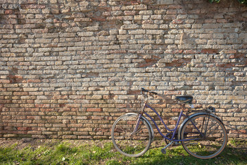 Fototapeta na wymiar old bicycle parked long an external wall in Burano island, Venic
