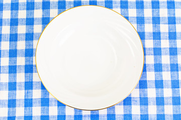 White Plate on a Checkered Tablecloth with Place for Your Text