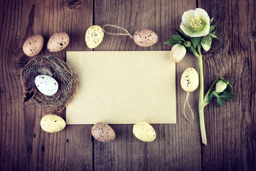 Vintage Easter decoration on dark wooden background with copy space.