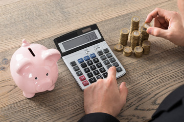 Close-up Of A Businessman Counting Coins