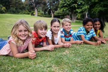 Fototapeta premium Happy children lying on grass