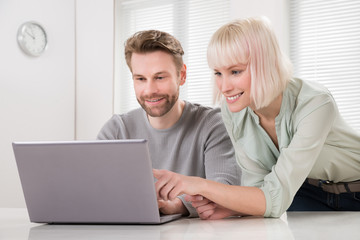 Young Couple Using Laptop