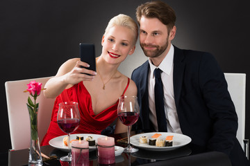 Young Couple Taking Selfie With Their Smartphone