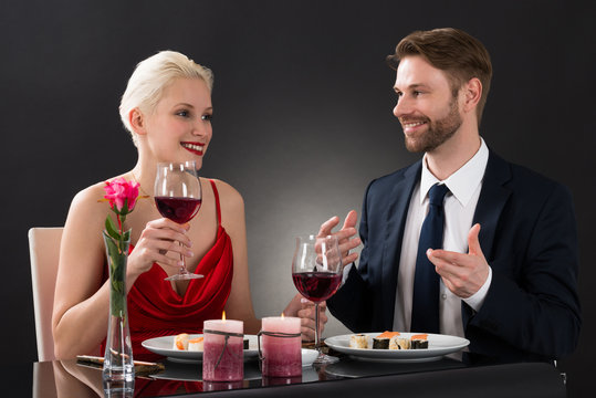 Young Couple Having Dinner In A Restaurant