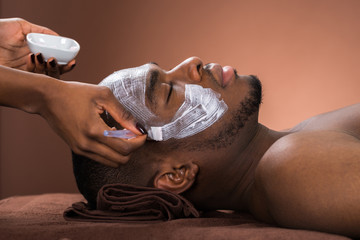 Therapist Applying Face Mask To Man