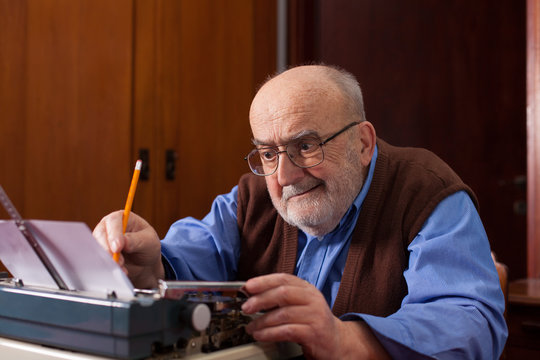 Old Man Typing On A Typewriter