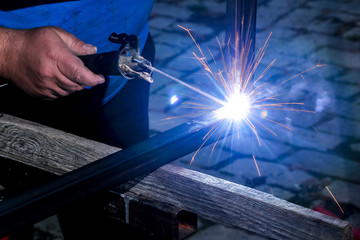 Semi professional welder welding a piece of metal