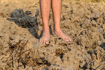 standing on dry and cracked ground,barren ground