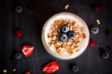Healthy breakfast - yogurt with blueberries and muesli served in bank