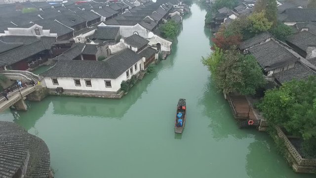 Aerial of Wuzhen, Old houses on the riverbanks feature white walls, gray-tiled rooftops and delicate woodcarvings, and represent a example of Chinese traditional architecture.