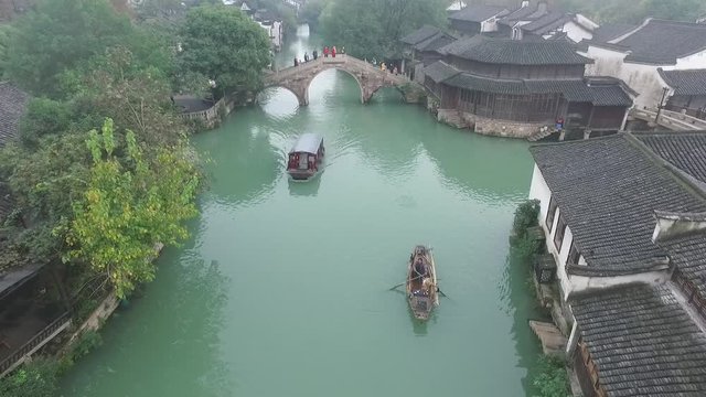 Aerial of Wuzhen, Old houses on the riverbanks feature white walls, gray-tiled rooftops and delicate woodcarvings, and represent a example of Chinese traditional architecture.