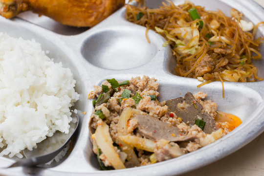 closeup stainless tray with thai food, shallow depth of field.