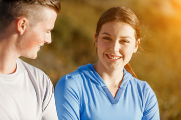 Young couple on beach in sportwear