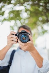 Close-up of man using camera