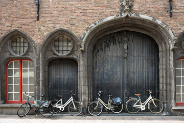 Fototapeta na wymiar Bicycles leaning against old wooden door