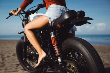 Plakat young pretty hipster girl Biker girl sitting on vintage custom motorcycle Biker girl sitting Outdoor lifestyle portrait. jeans short denim, fashion style