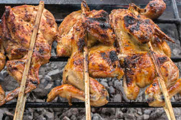 Hot skewer roasting chicken on Grilled rack, thai local food