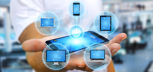 Businessman connecting tech device with his phone