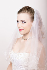 Beautiful bride with fashion wedding hairstyle. Close-up portrait of young gorgeous bride. Wedding. 