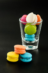 Colorful macarons with glass cup.