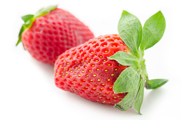 Two strawberries close up.