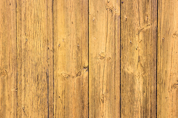 Yellow peeling paint wooden wall.