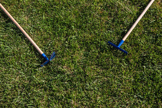 shovel and rake over green grass